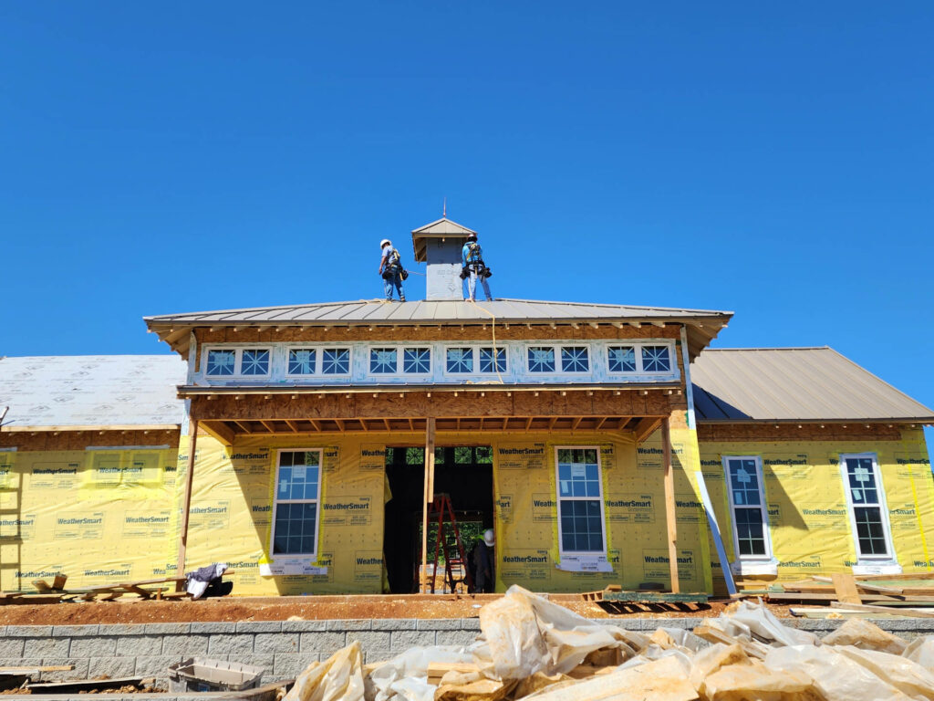 Men working on roof of building