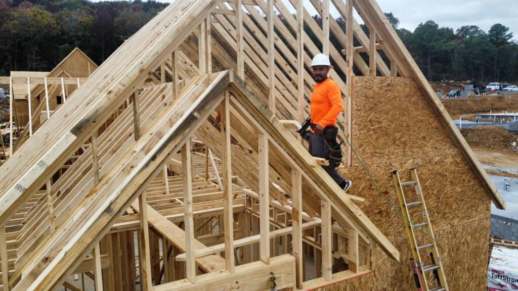 Man on top doing framing work