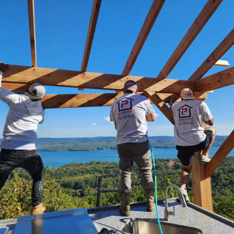 Pendergraft Construction crew building an outdoor kitchen pergola overlooking Lake Guntersville