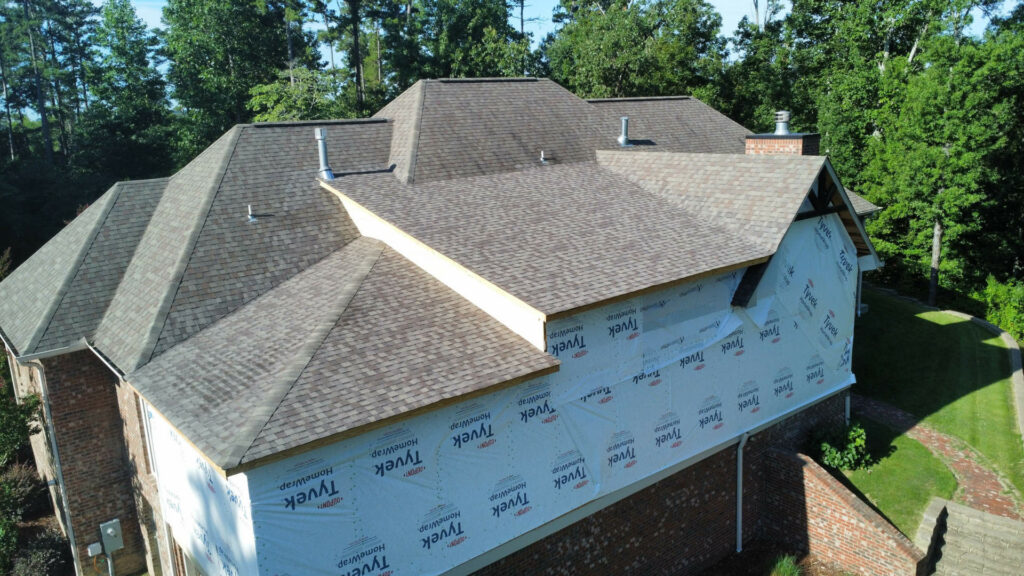 Newly shingled roof on a brick estate home addition