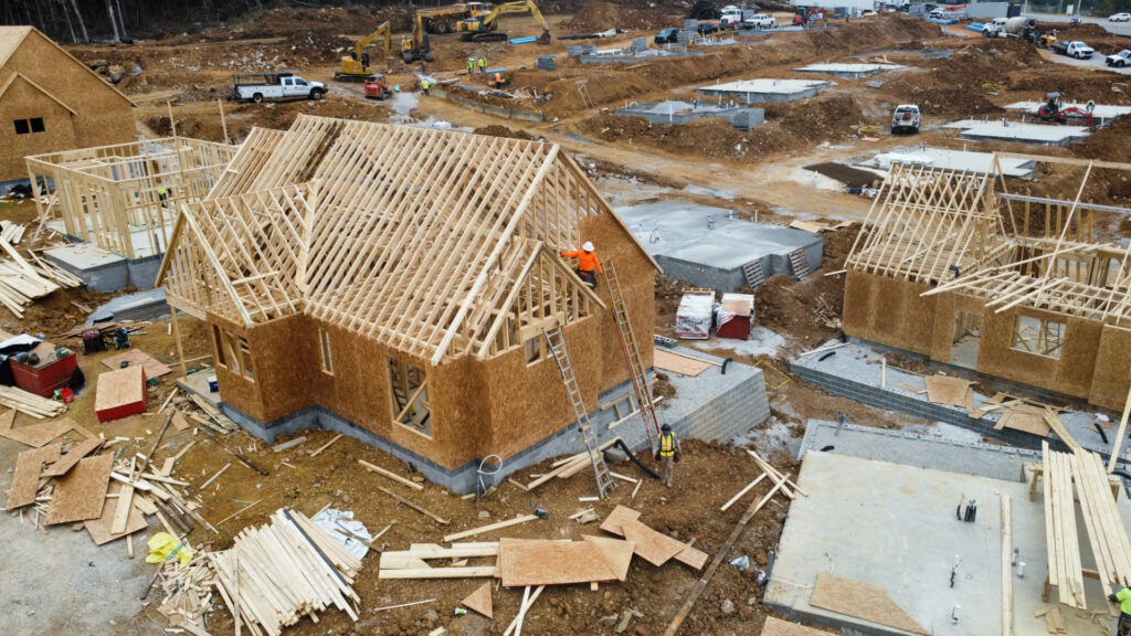 Aerial view of framing crew at work in a new subdivision