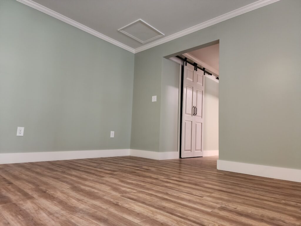 Newly finshed interior room with hardwood floors and freshly painted walls