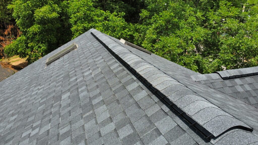 Close-up of a ridge vent installed along a new asphalt shingle roof