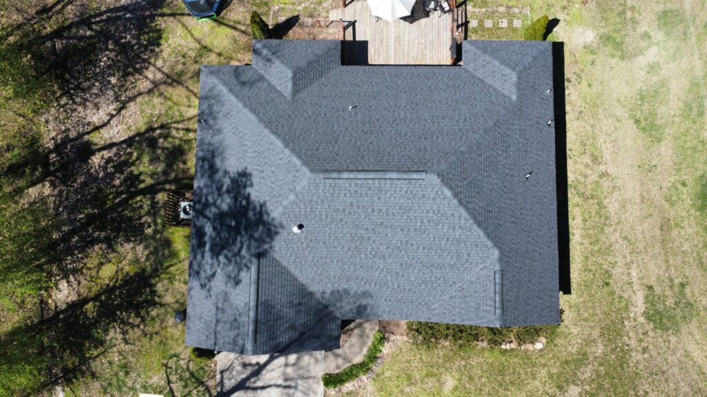 Aerial drone view of a completed gray asphalt shingle roof on a home in North Alabama
